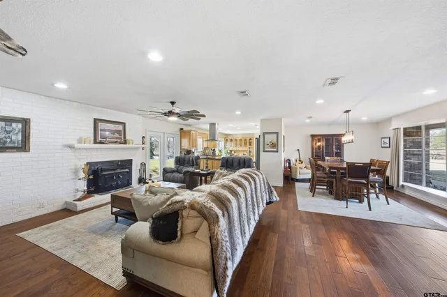 a living room with fireplace furniture and a wooden floor