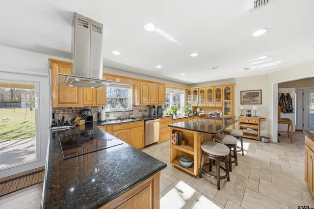 a living room with lots of furniture and a large window