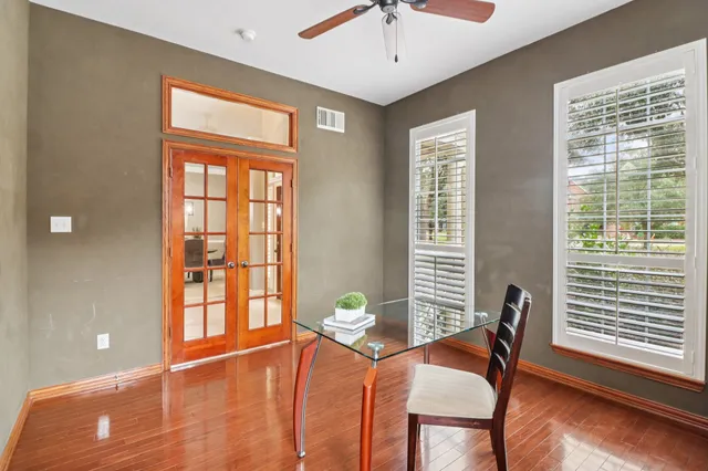 a living room with furniture and flowers