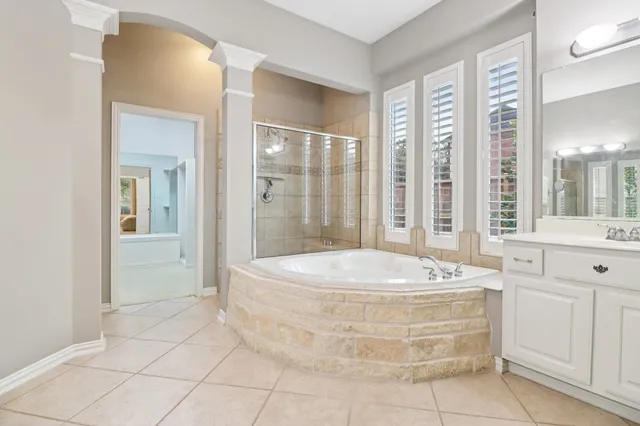 a spacious bathroom with a tub shower and sink