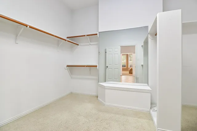 a spacious bathroom with a mirror sink and shower