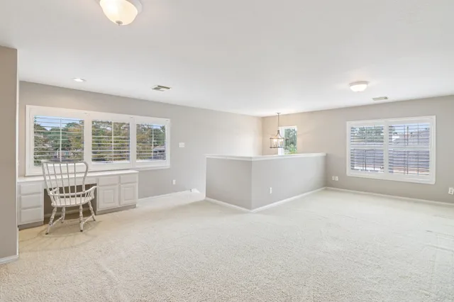 a view of a livingroom with furniture and a large window