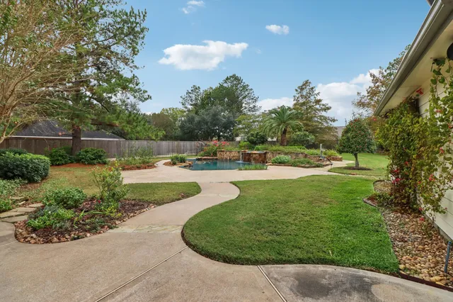 a view of a house with swimming pool and sitting area