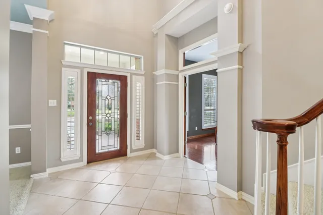 a living room with furniture a fireplace and a chandelier