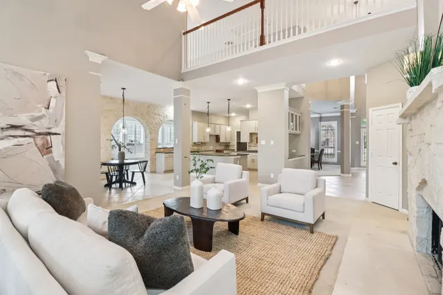 a living room with kitchen island furniture and a chandelier