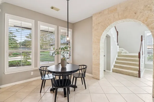 a large kitchen with granite countertop a large counter top stainless steel appliances and cabinets