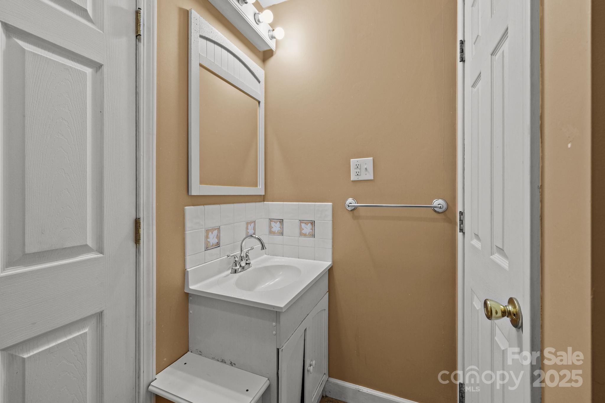 123 North Main Street Salisbury, NC 28144 - Photo 17 of 47 a bathroom with a sink and mirror with toilet