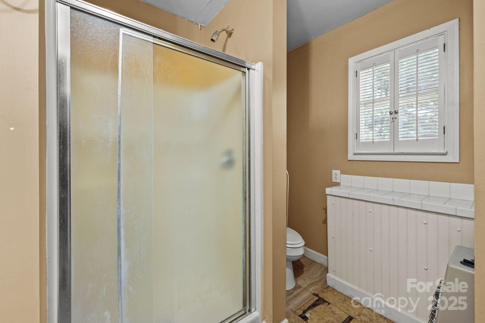 123 North Main Street Salisbury, NC 28144 - Photo 18 of 47 a bathroom with a granite countertop sink toilet and shower