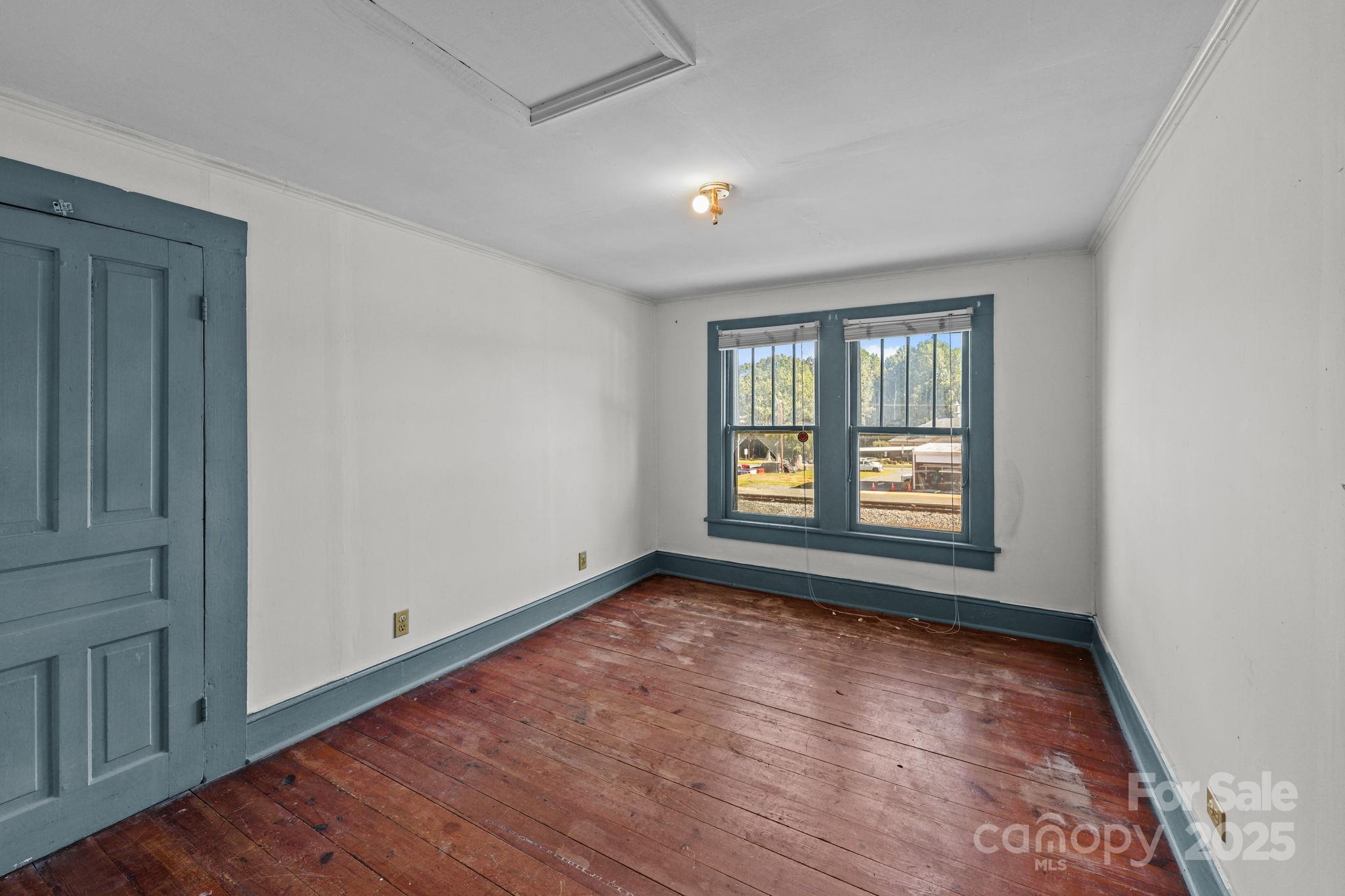 123 North Main Street Salisbury, NC 28144 - Photo 25 of 47 a view of an empty room with wooden floor and a window