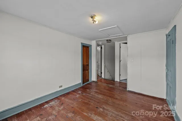 a view of a room with a window and a ceiling fan