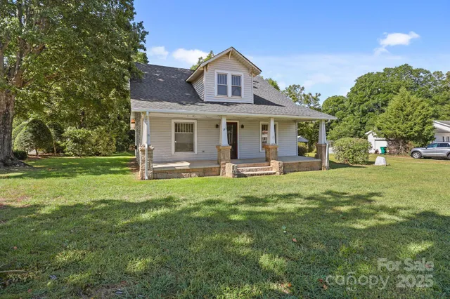 a view of a house with a backyard and a patio