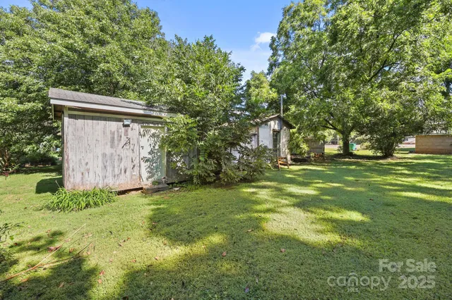 a backyard of a house with lots of green space and fountain