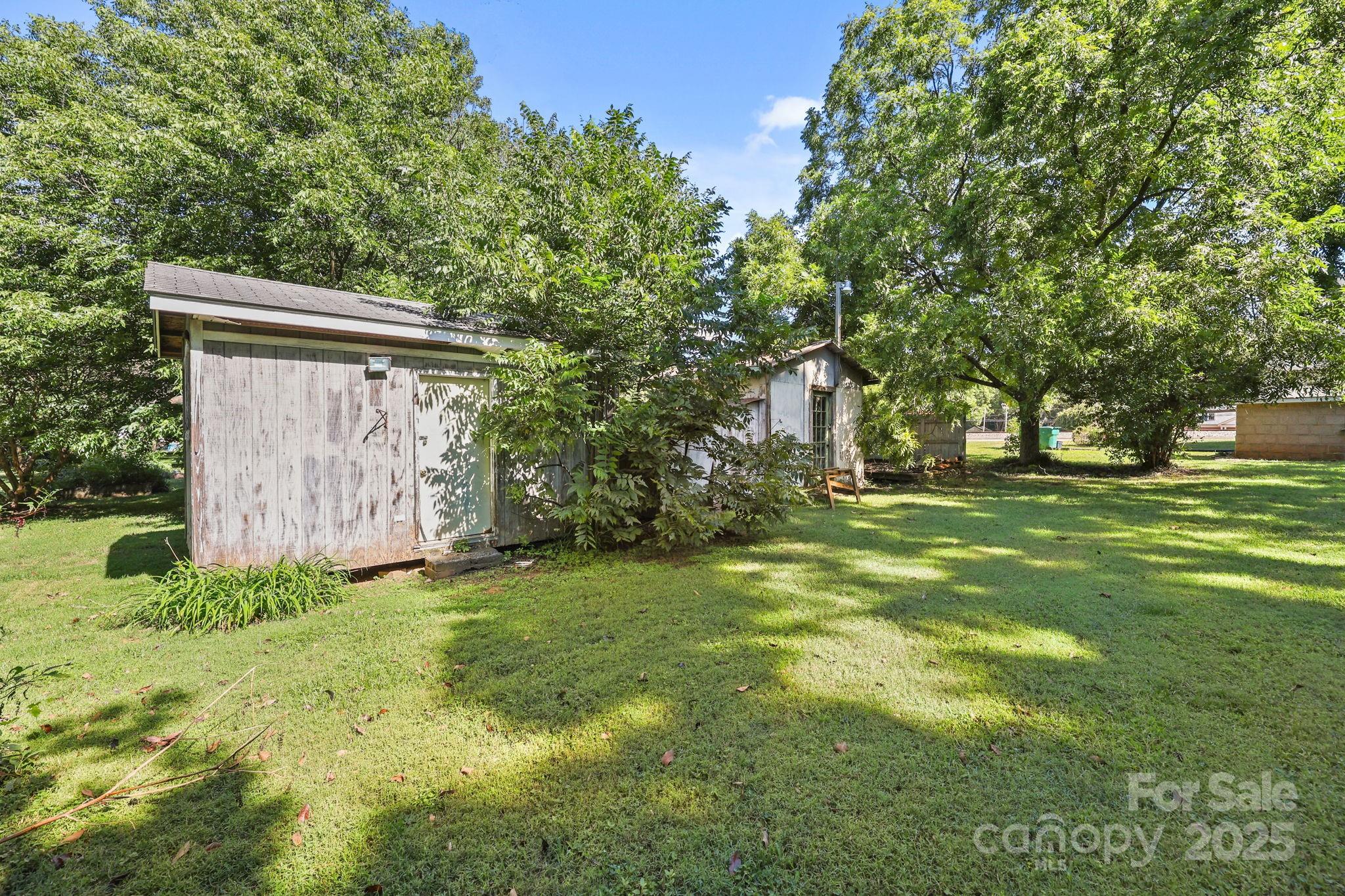 123 North Main Street Salisbury, NC 28144 - Photo 36 of 47 a backyard of a house with lots of green space and fountain