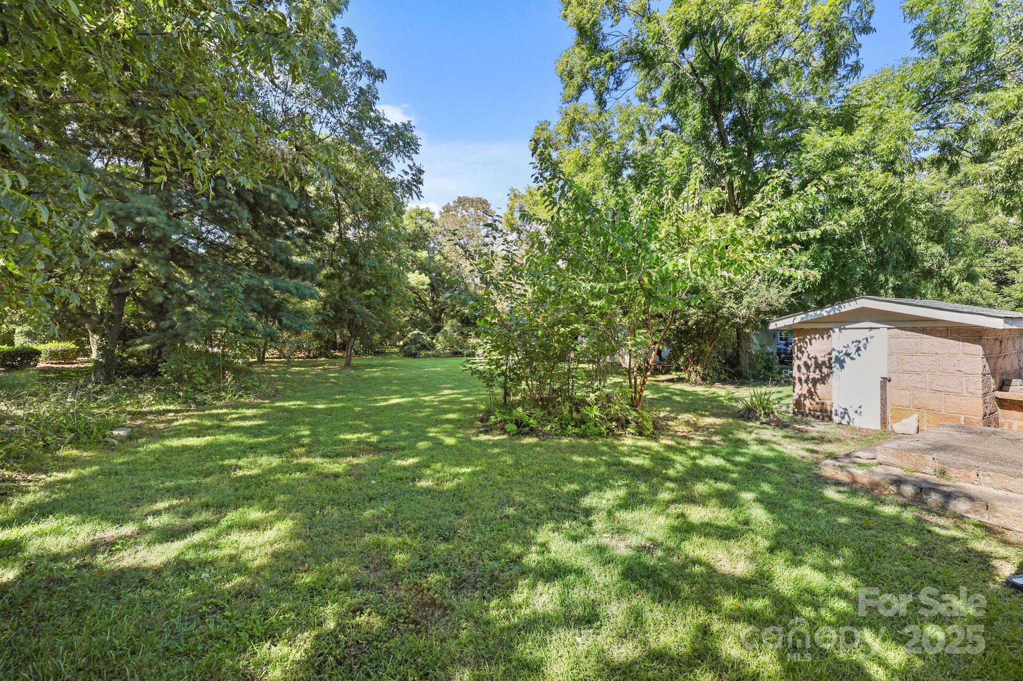 123 North Main Street Salisbury, NC 28144 - Photo 37 of 47 a backyard of a house with lots of green space and fountain