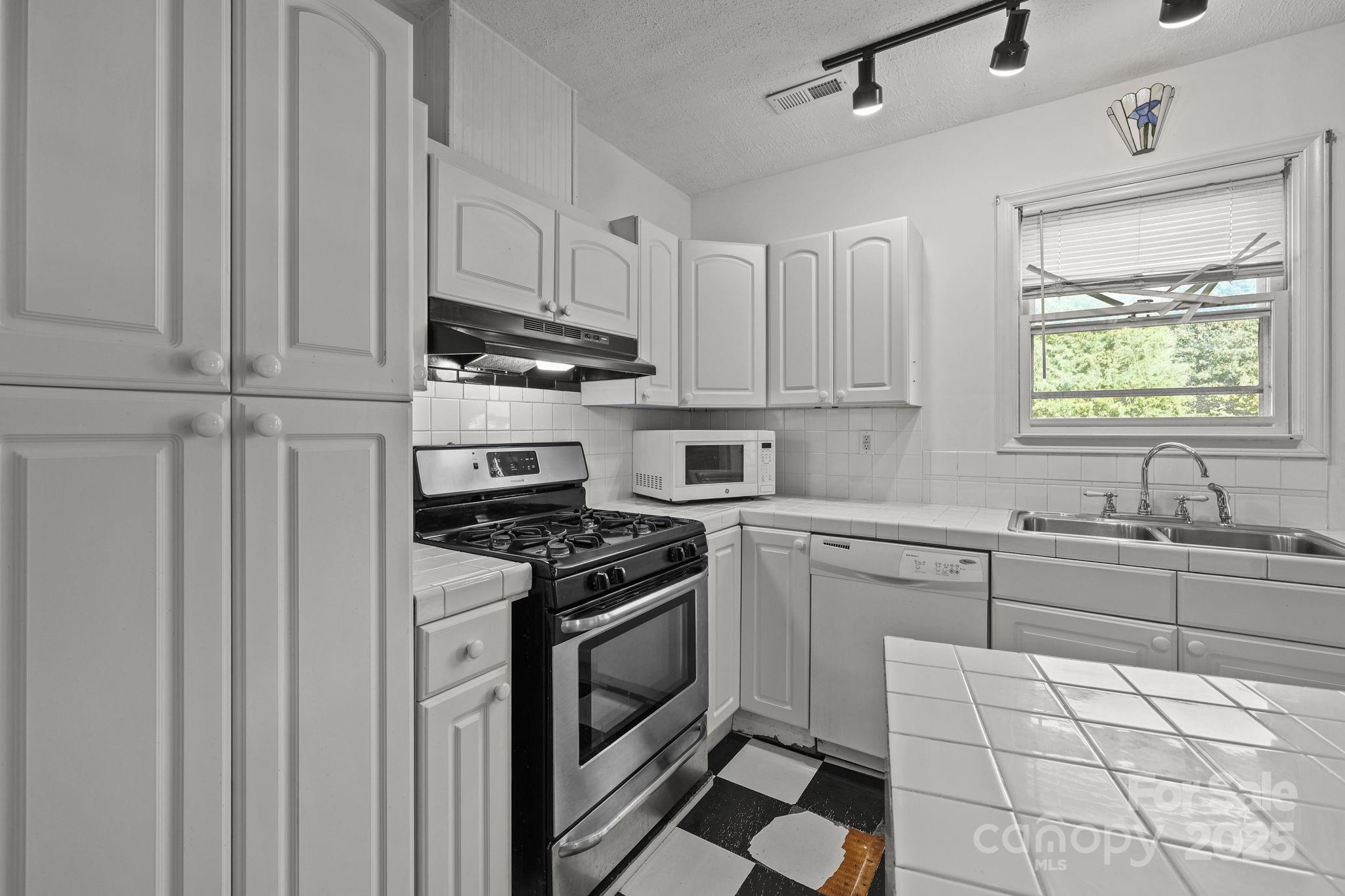 123 North Main Street Salisbury, NC 28144 - Photo 6 of 47 a kitchen with granite countertop white cabinets and appliances