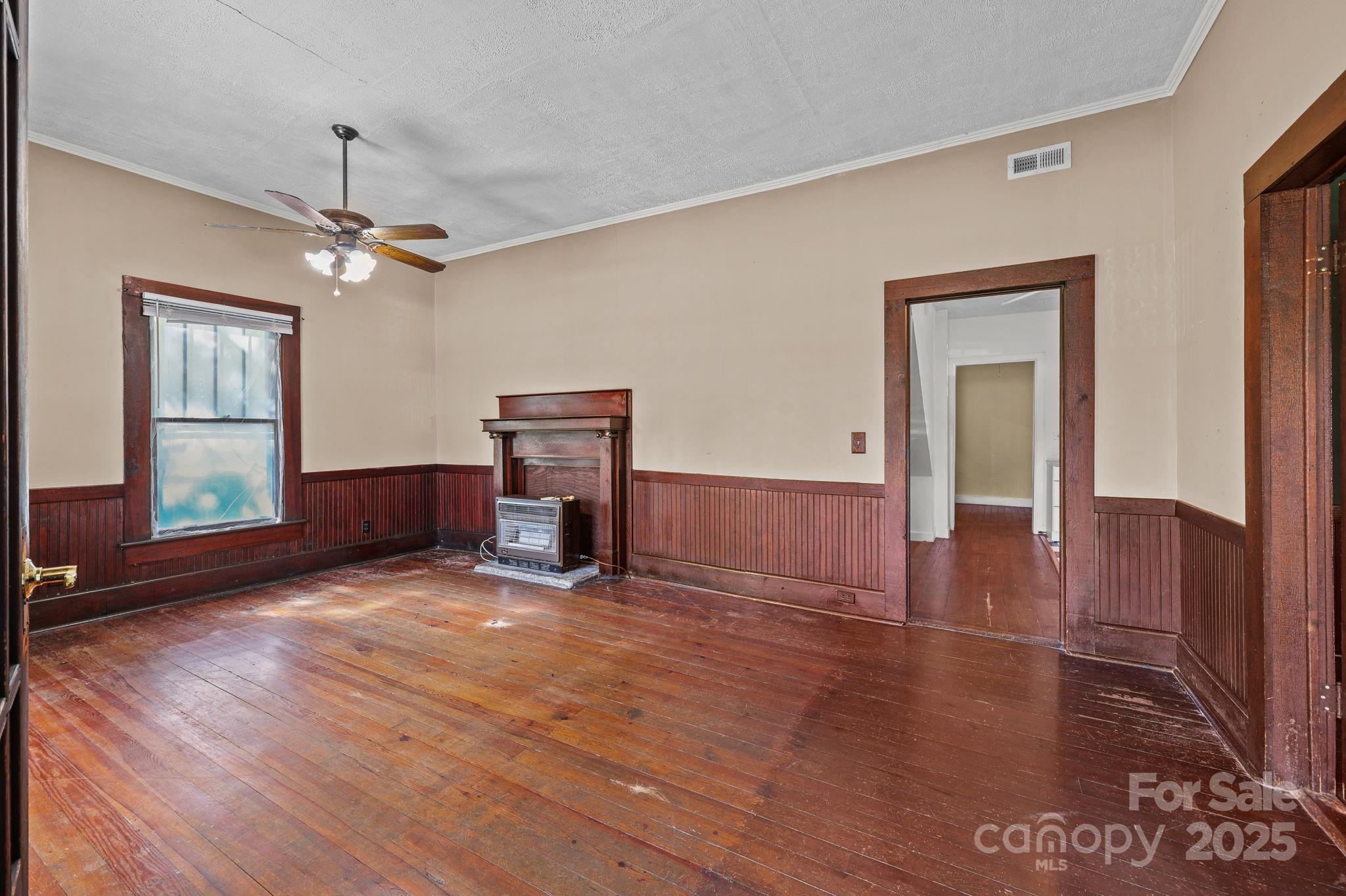 123 North Main Street Salisbury, NC 28144 - Photo 9 of 47 a view of empty room with wooden floor and fan