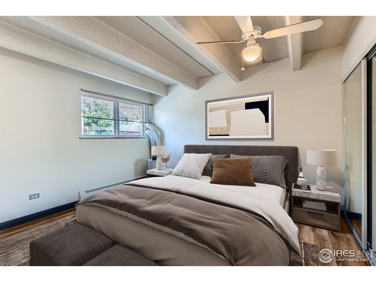 1265 Elizabeth Street, Unit 207 Denver, CO 80206 - Photo 11 of 19 a bedroom with a bed and a painting on the wall