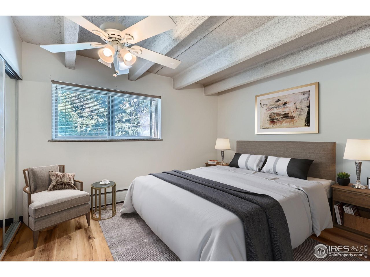 1265 Elizabeth Street, Unit 207 Denver, CO 80206 - Photo 13 of 19 a bedroom with a bed and a chandelier