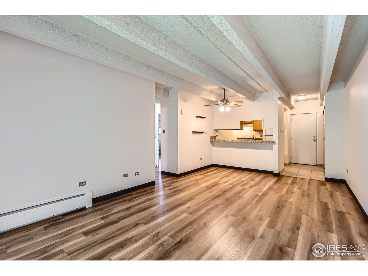 1265 Elizabeth Street, Unit 207 Denver, CO 80206 - Photo 5 of 19 a view of a room with wooden floor