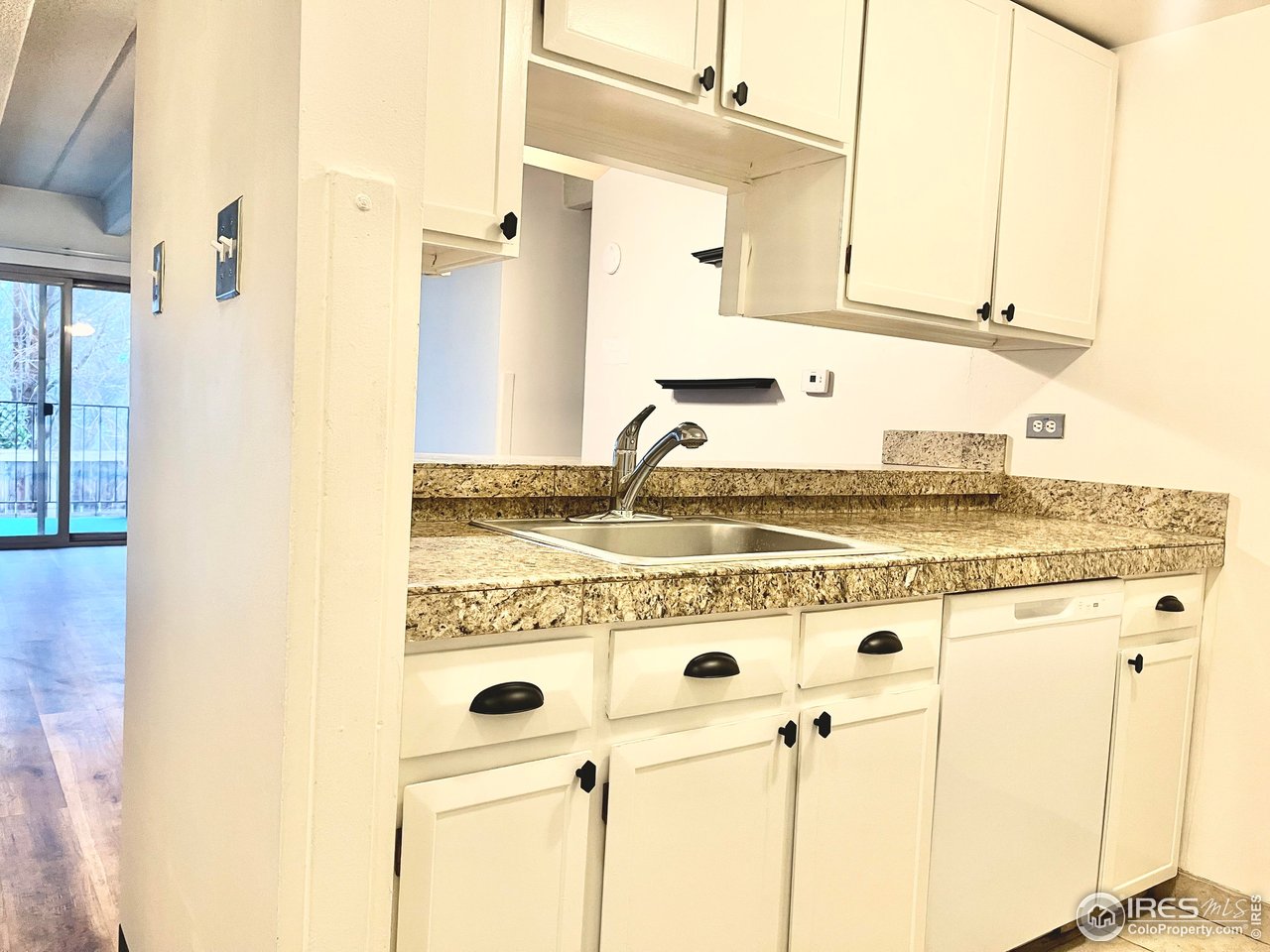 1265 Elizabeth Street, Unit 207 Denver, CO 80206 - Photo 7 of 19 a kitchen with stainless steel appliances granite countertop a sink and a stove