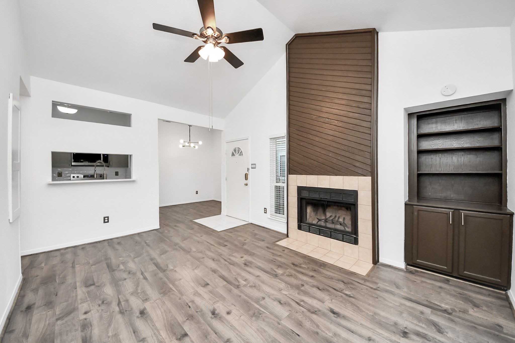3500 Tangle Brush Drive, Unit 186 Spring, TX 77381 - Photo 11 of 43 a view of a livingroom with a fireplace a ceiling fan and closet