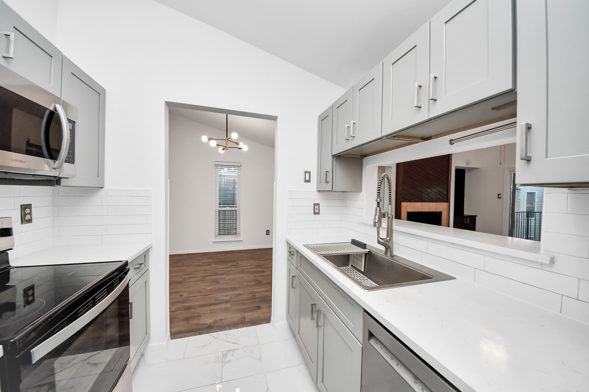 3500 Tangle Brush Drive, Unit 186 Spring, TX 77381 - Photo 27 of 43 a kitchen with granite countertop a sink and a stove top oven