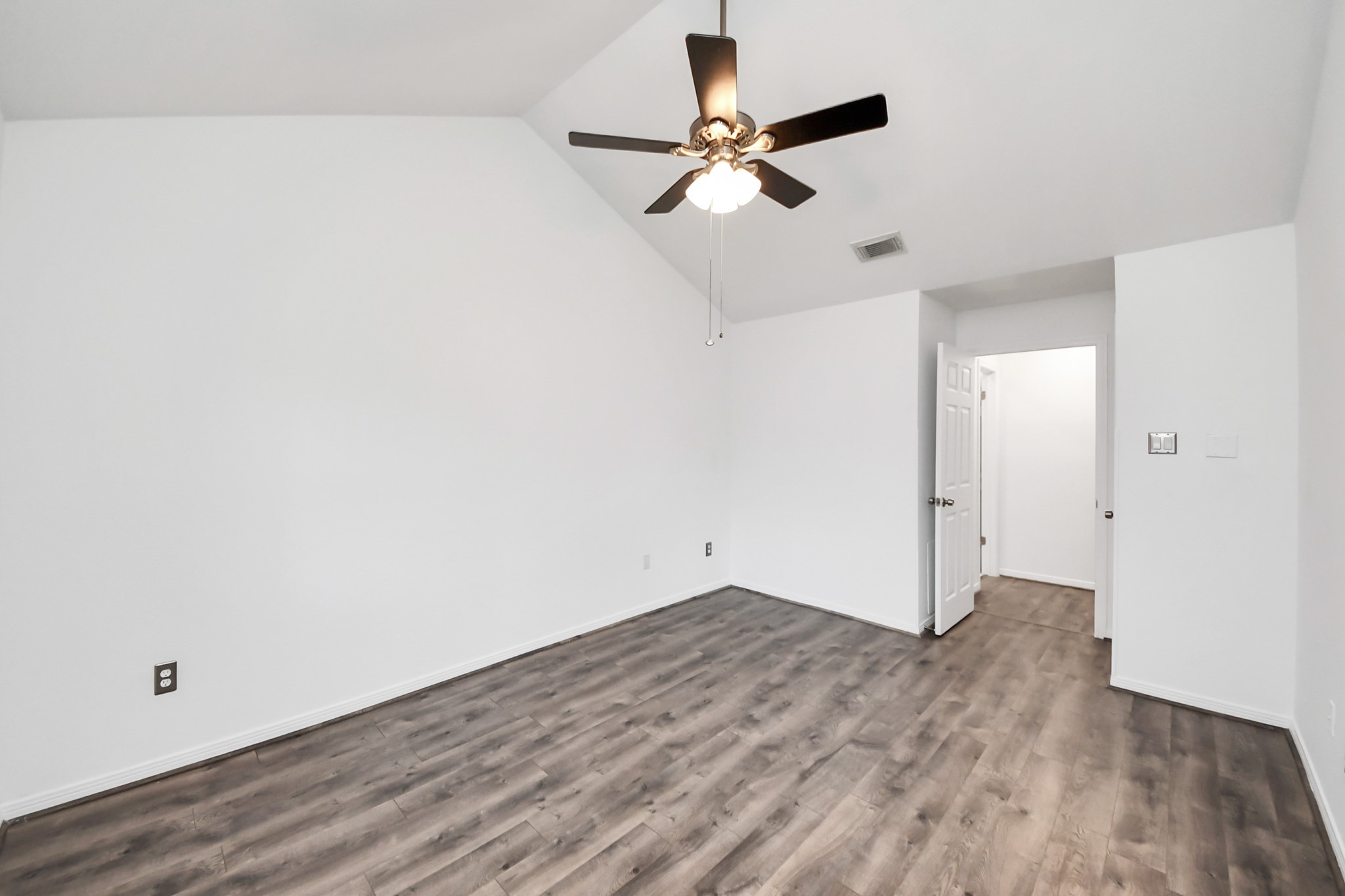 3500 Tangle Brush Drive, Unit 186 Spring, TX 77381 - Photo 33 of 43 an empty room with wooden floor fan and windows
