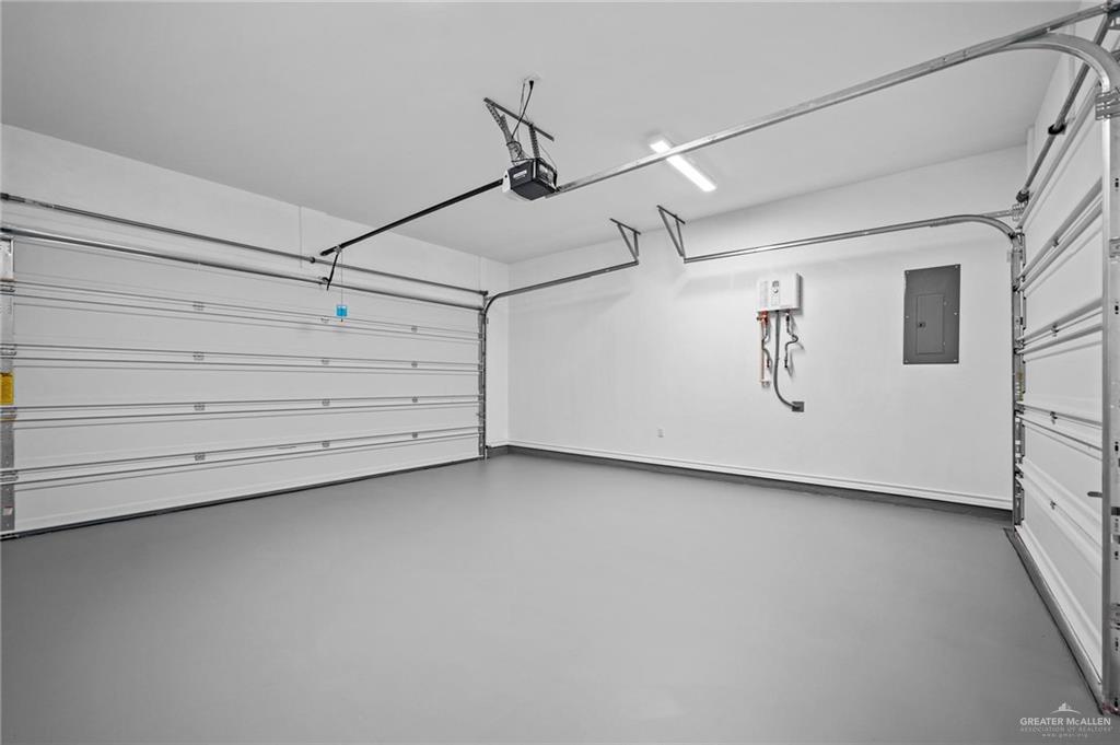 2716 East Conroe Road Edinburg, TX 78542 - Photo 24 of 31 Garage featuring electric panel and a garage door opener
