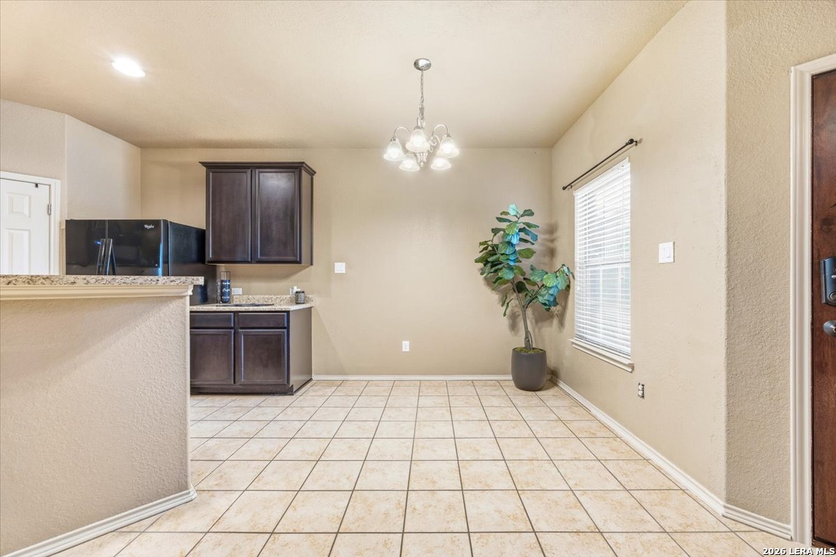 3831 Bacall Way Converse, TX 78109 - Photo 8 of 33 a kitchen with stainless steel appliances a stove a sink a microwave and cabinets