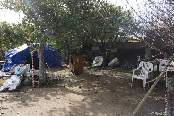 a view of a backyard with table and chairs and a fire pit