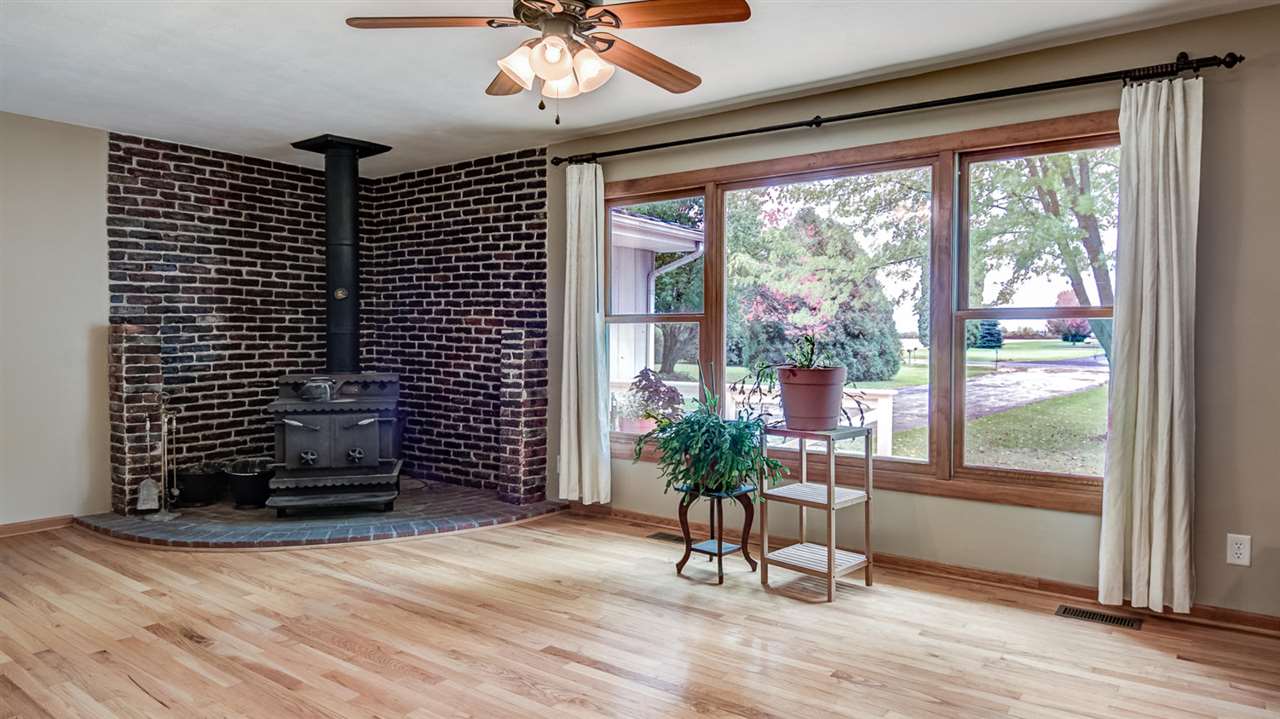 34477 Wheeler Road Kirkland, IL 60146 - Photo 4 of 25 a view of a livingroom with wooden floor and a large window