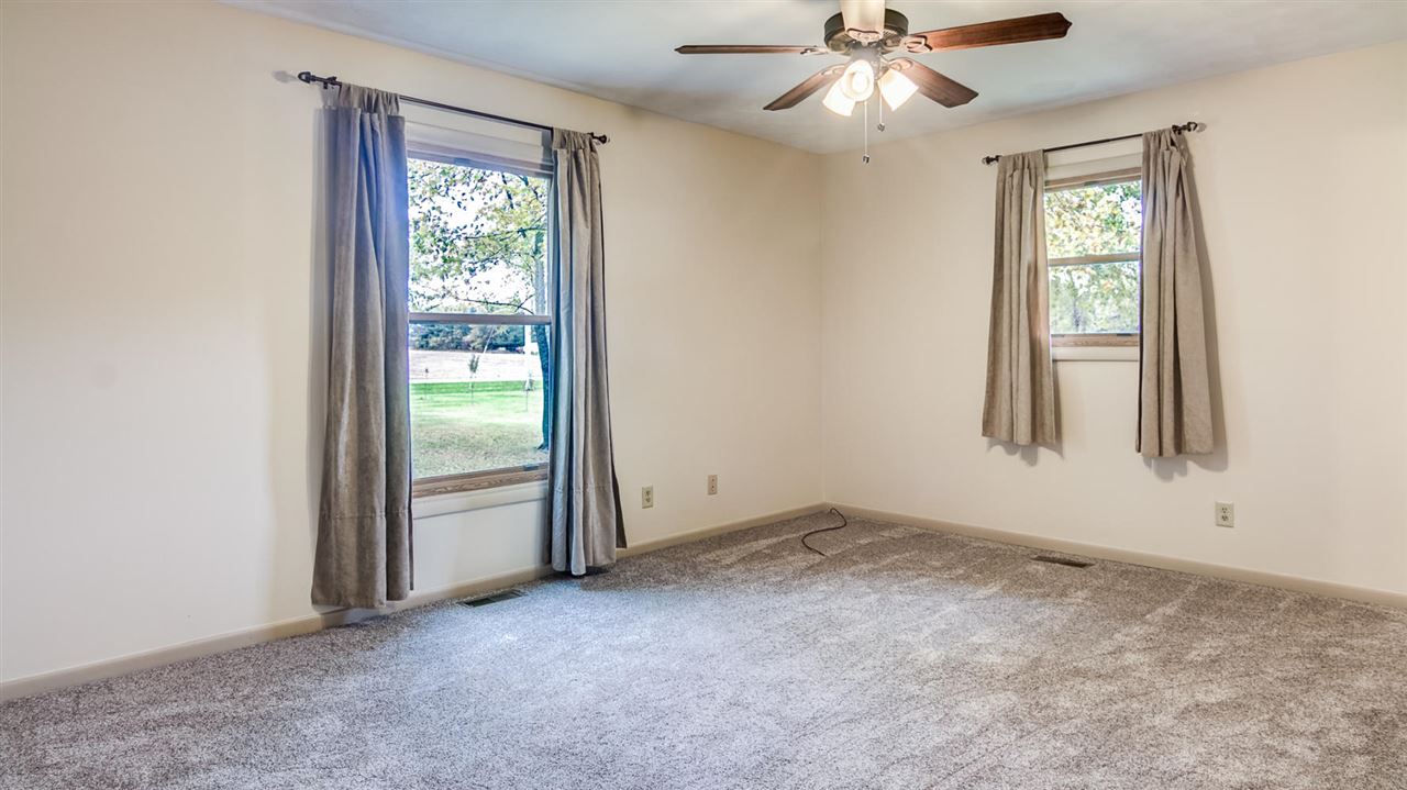 34477 Wheeler Road Kirkland, IL 60146 - Photo 10 of 25 an empty room with windows and fan