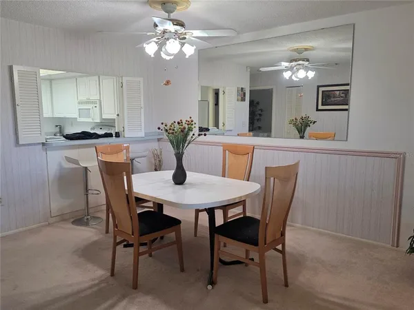 a view of a dining room with furniture and chandelier