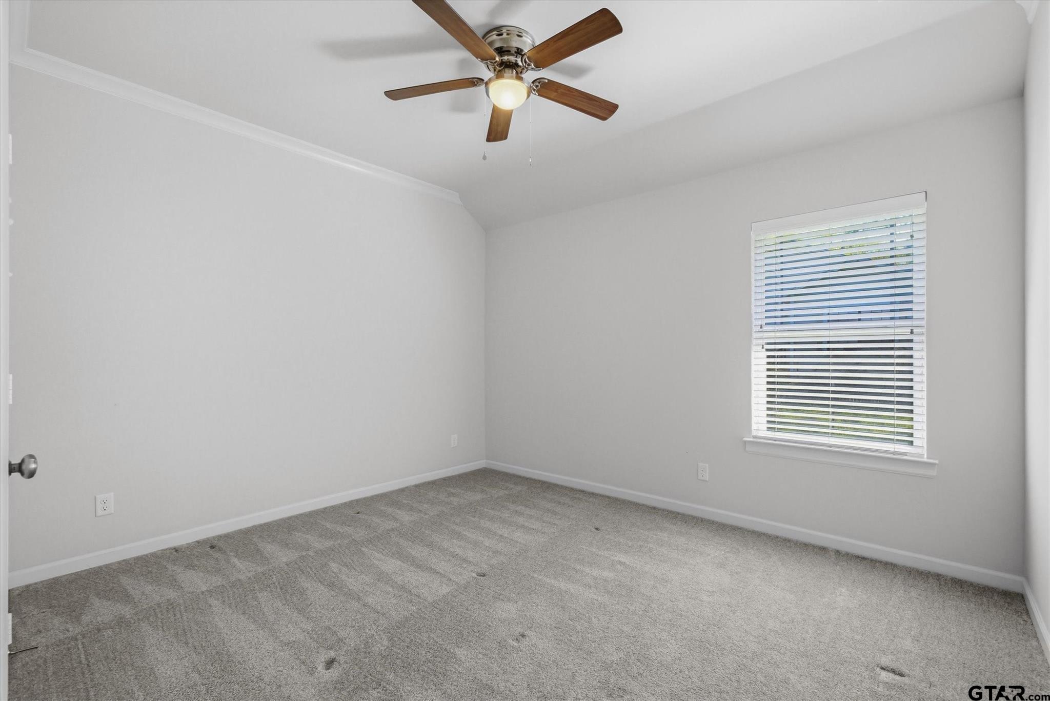 1011 Athens Street Canton, TX 75103 - Photo 23 of 38 an empty room with a window and a ceiling fan