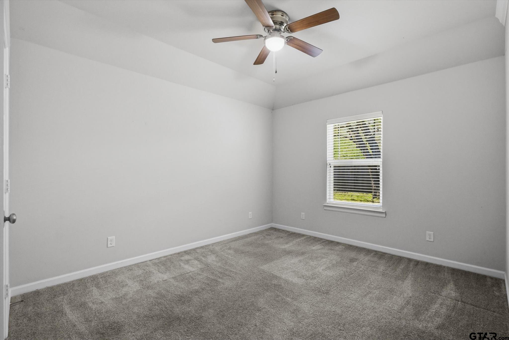 1011 Athens Street Canton, TX 75103 - Photo 26 of 38 an empty room with windows and ceiling fan