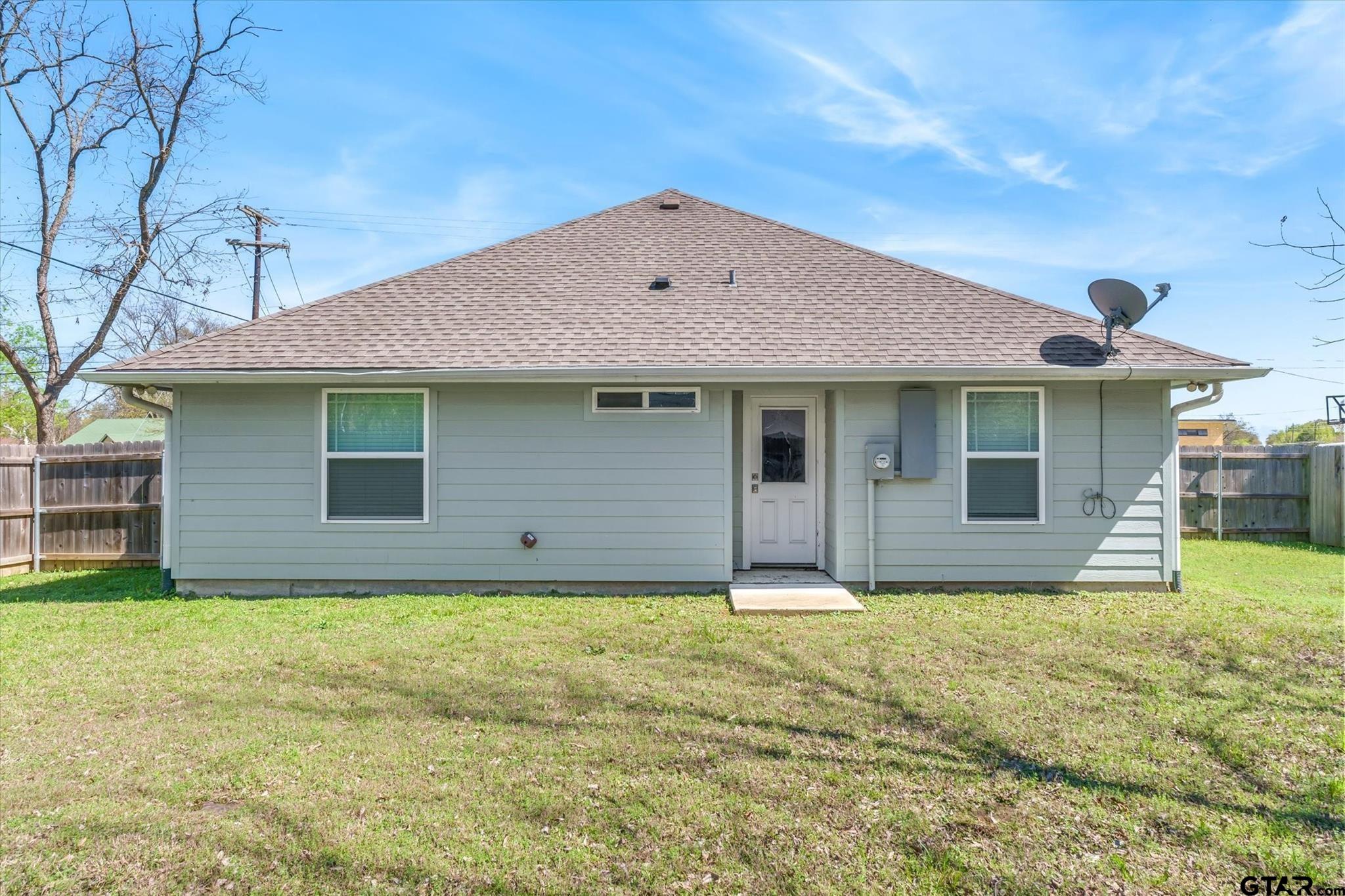 1011 Athens Street Canton, TX 75103 - Photo 30 of 38 a front view of house with yard and trees in the background