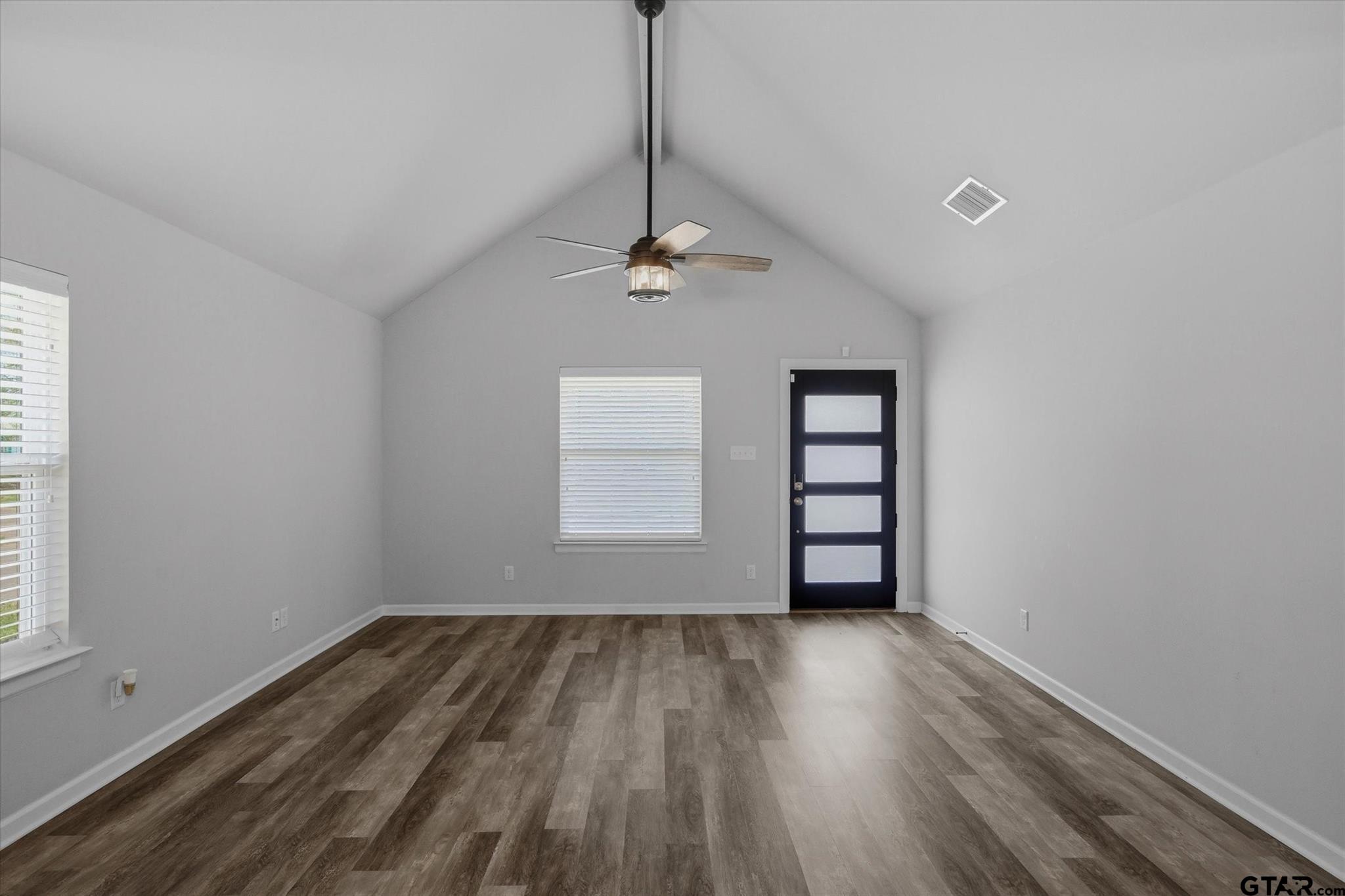1011 Athens Street Canton, TX 75103 - Photo 7 of 38 a view of empty room with wooden floor and fan
