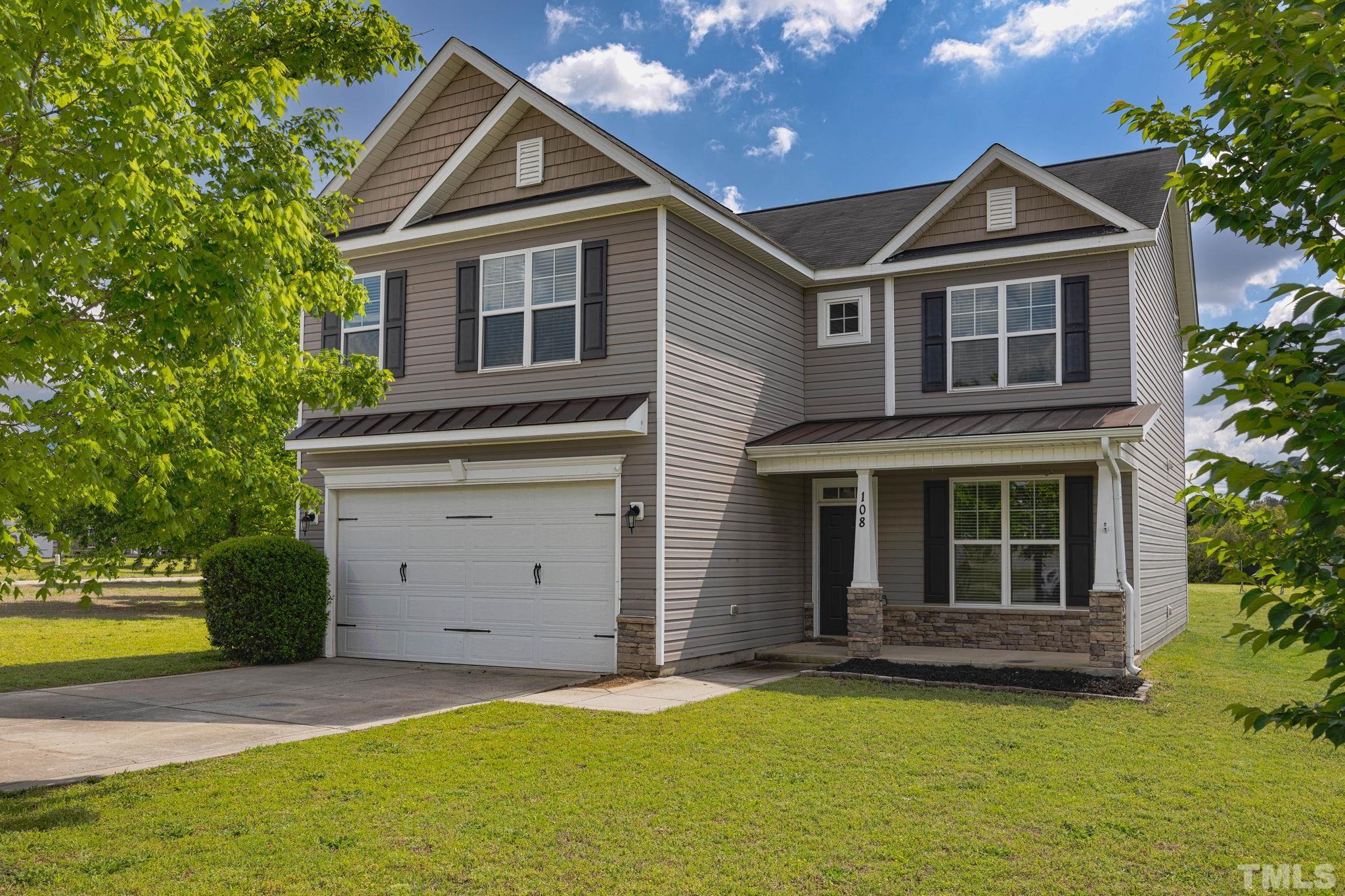 108 Riley Lane Cameron, NC 28326 - Photo 1 of 29 a front view of a house with a garden and yard