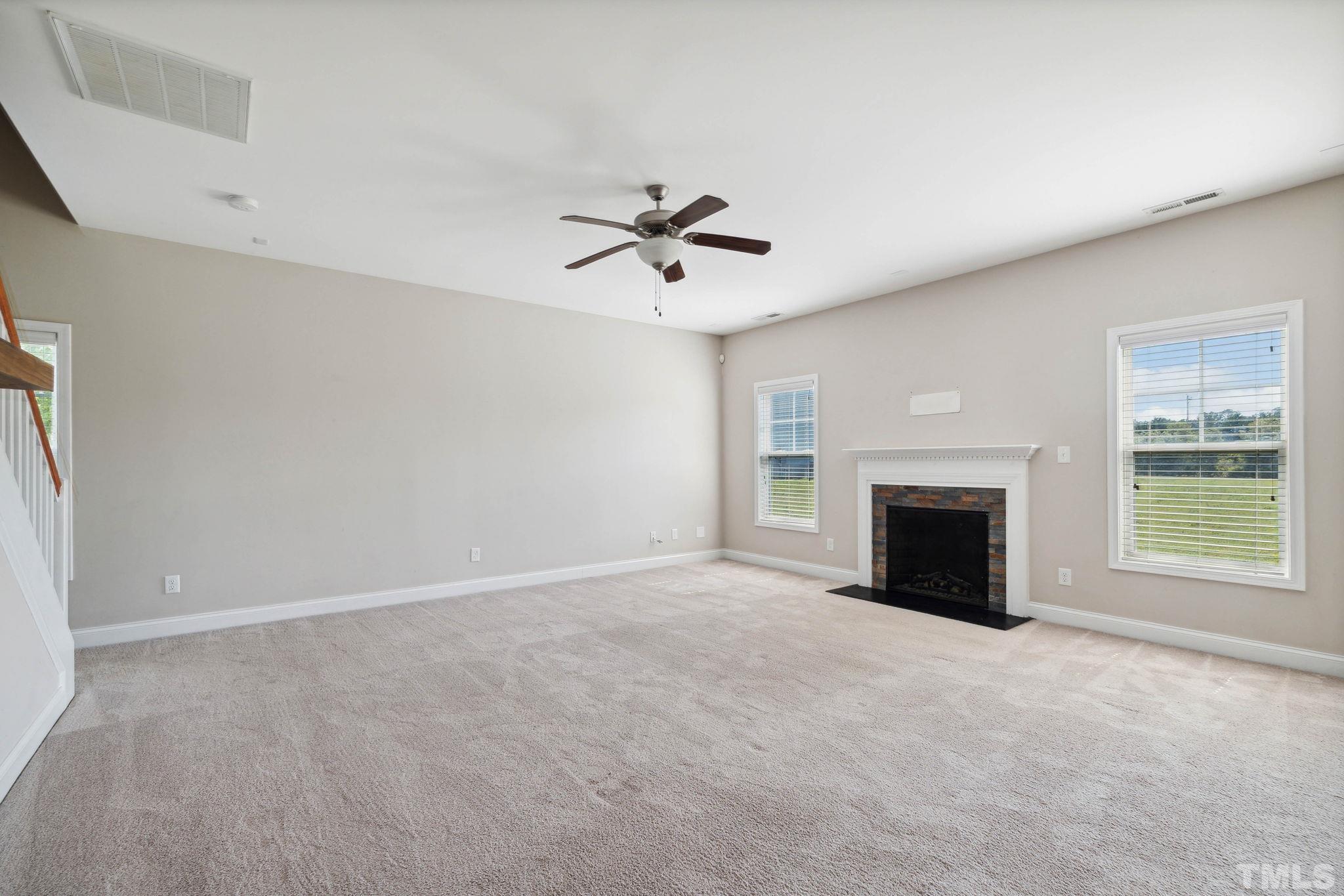 108 Riley Lane Cameron, NC 28326 - Photo 11 of 29 an empty room with fireplace and windows
