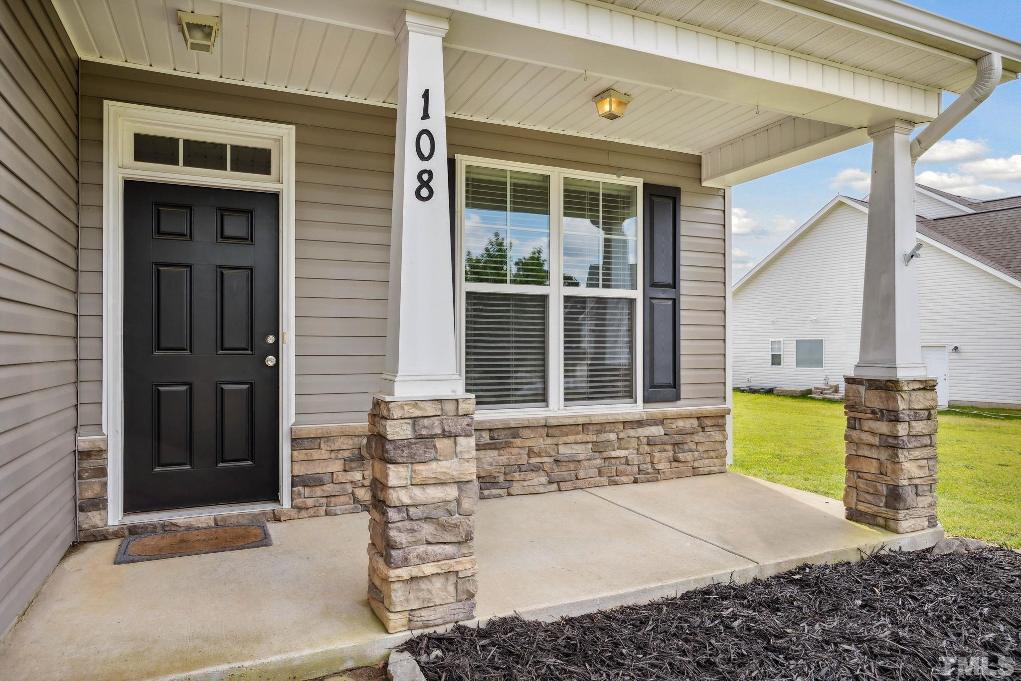 108 Riley Lane Cameron, NC 28326 - Photo 2 of 29 a front view of a house with a garden
