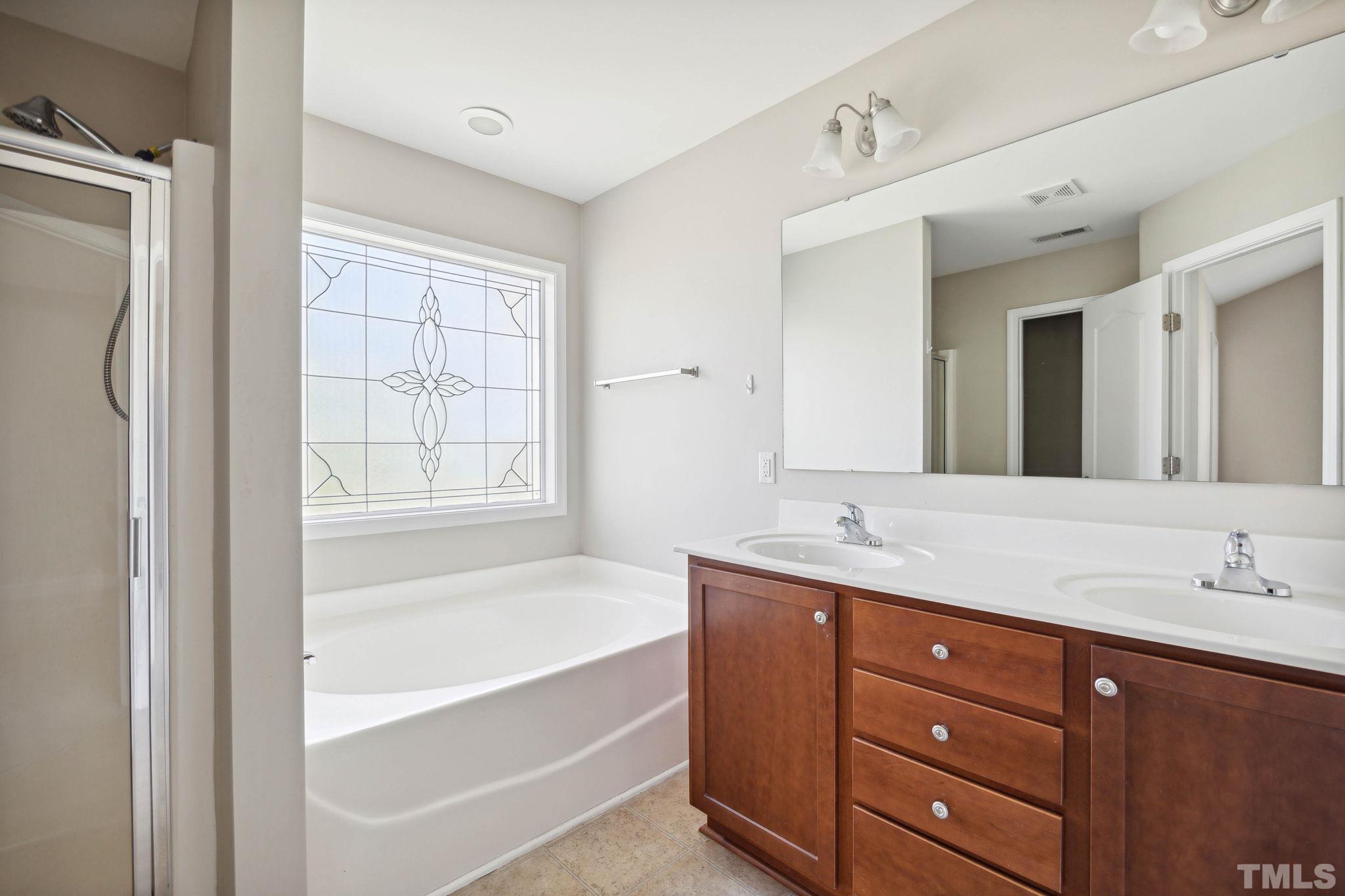 108 Riley Lane Cameron, NC 28326 - Photo 21 of 29 a bathroom with a tub double vanity sink and mirror