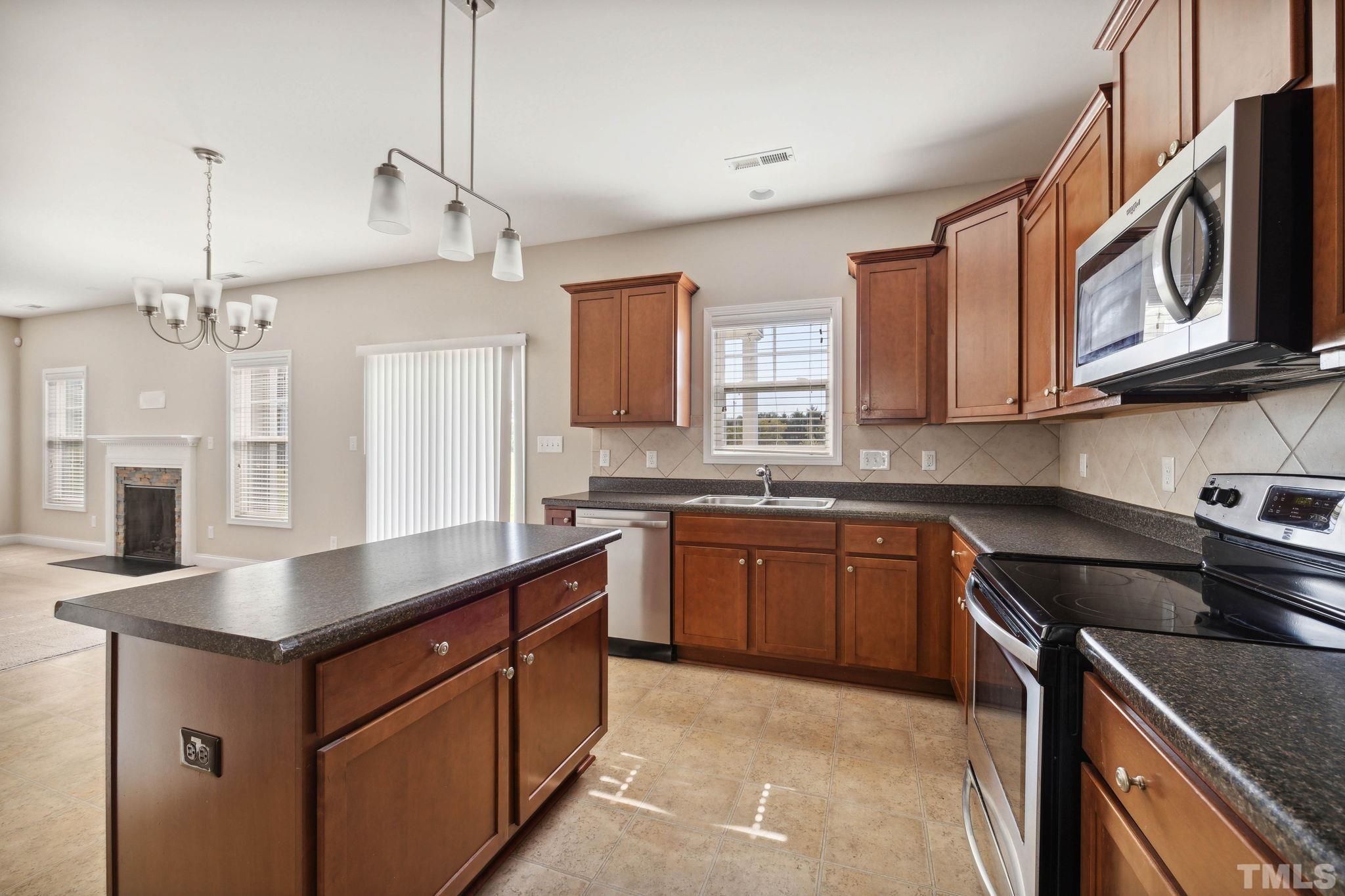 108 Riley Lane Cameron, NC 28326 - Photo 5 of 29 a kitchen with stainless steel appliances granite countertop a sink stove and refrigerator