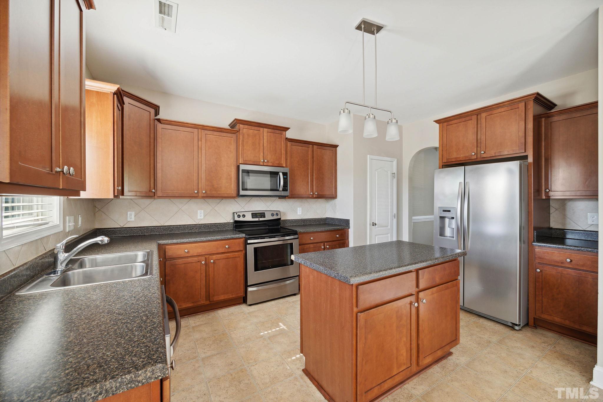 108 Riley Lane Cameron, NC 28326 - Photo 7 of 29 a kitchen with stainless steel appliances granite countertop a sink stove and refrigerator