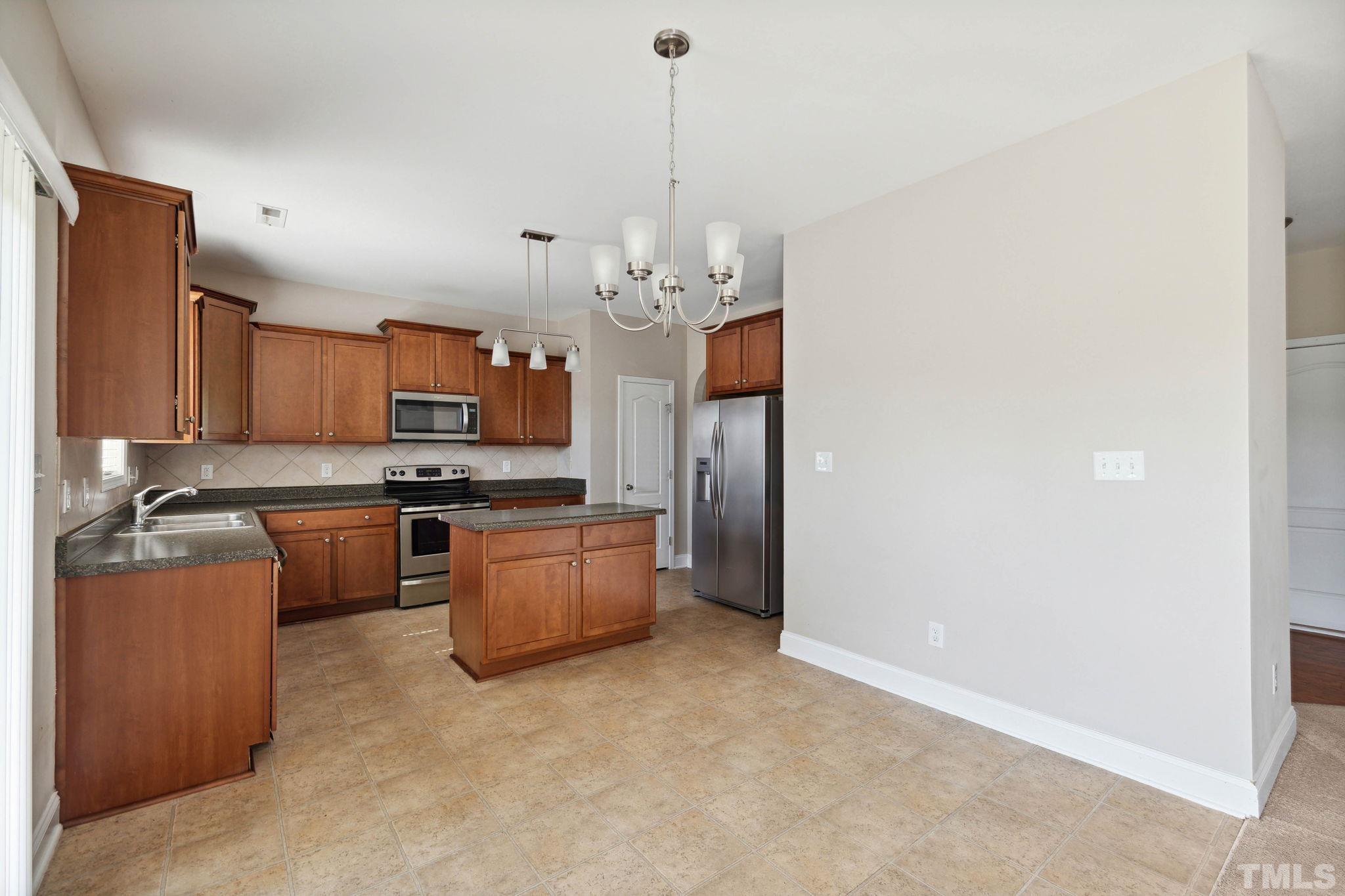 108 Riley Lane Cameron, NC 28326 - Photo 8 of 29 a kitchen with a refrigerator and a stove top oven