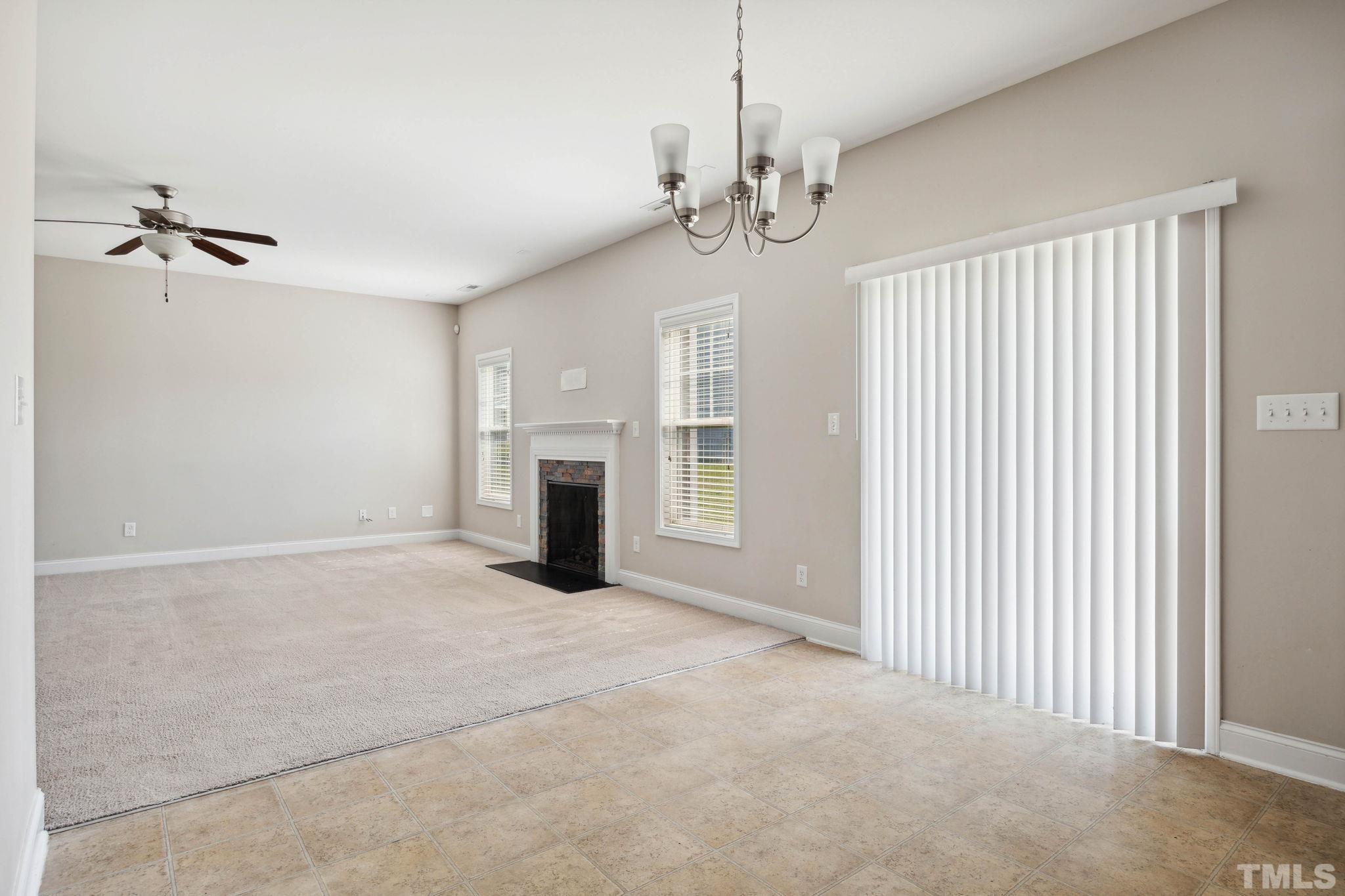 108 Riley Lane Cameron, NC 28326 - Photo 9 of 29 a view of a livingroom with a fireplace a ceiling fan and windows