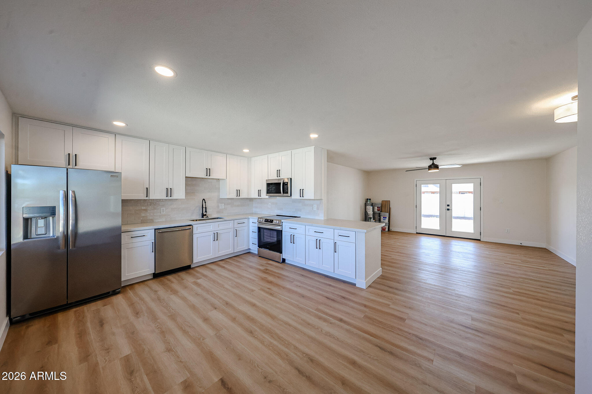 a large kitchen with stainless steel appliances kitchen island granite countertop a large counter top and stainless steel appliances