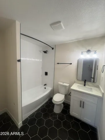 a bathroom with a sink toilet a mirror and shower