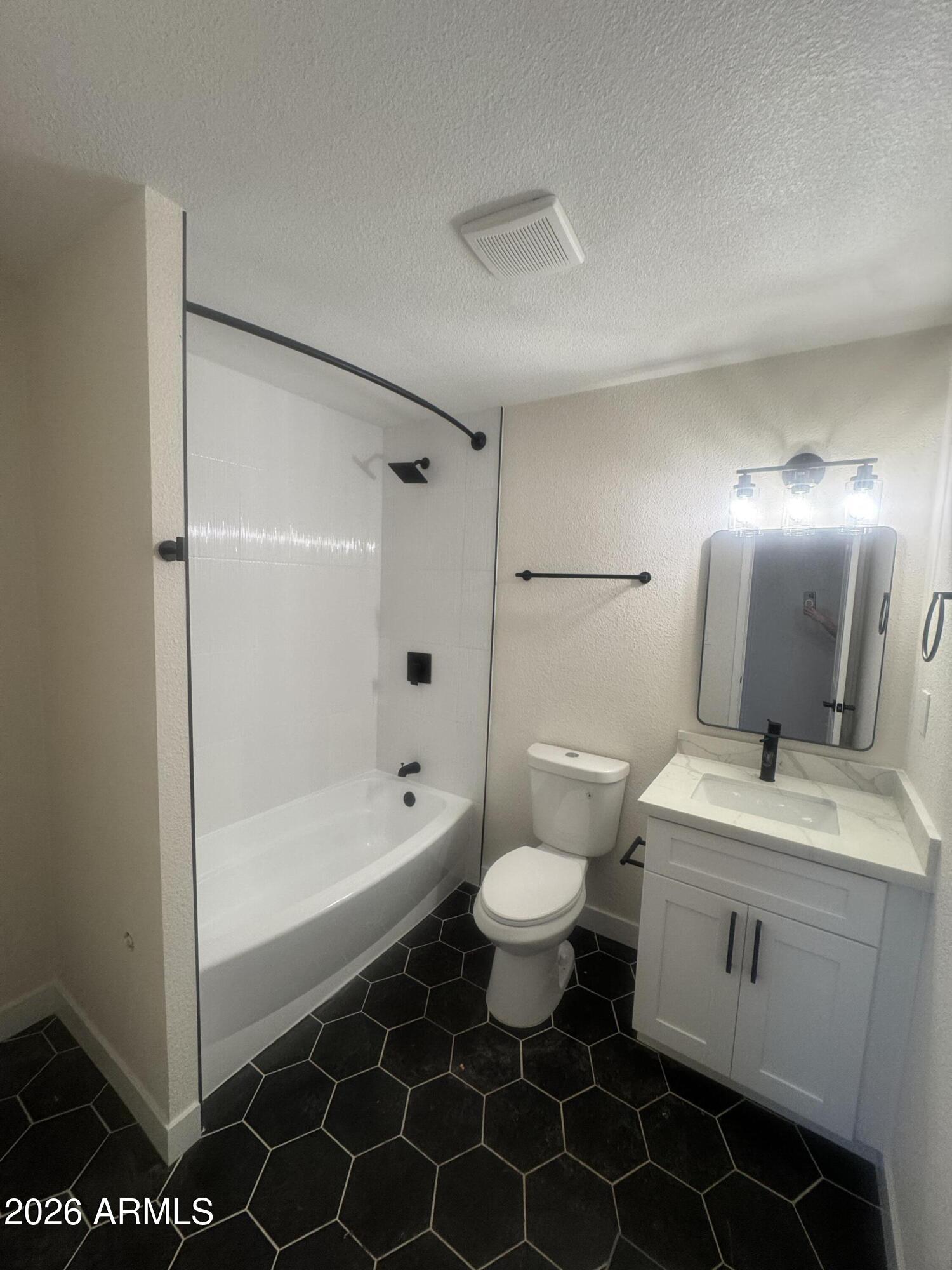 3337 West Ocotillo Road Phoenix, AZ 85017 - Photo 21 of 22 a bathroom with a sink toilet a mirror and shower