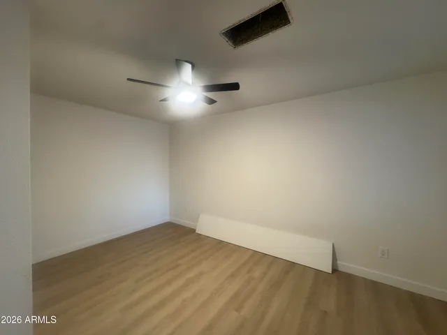 an empty room with a empty space and a ceiling fan