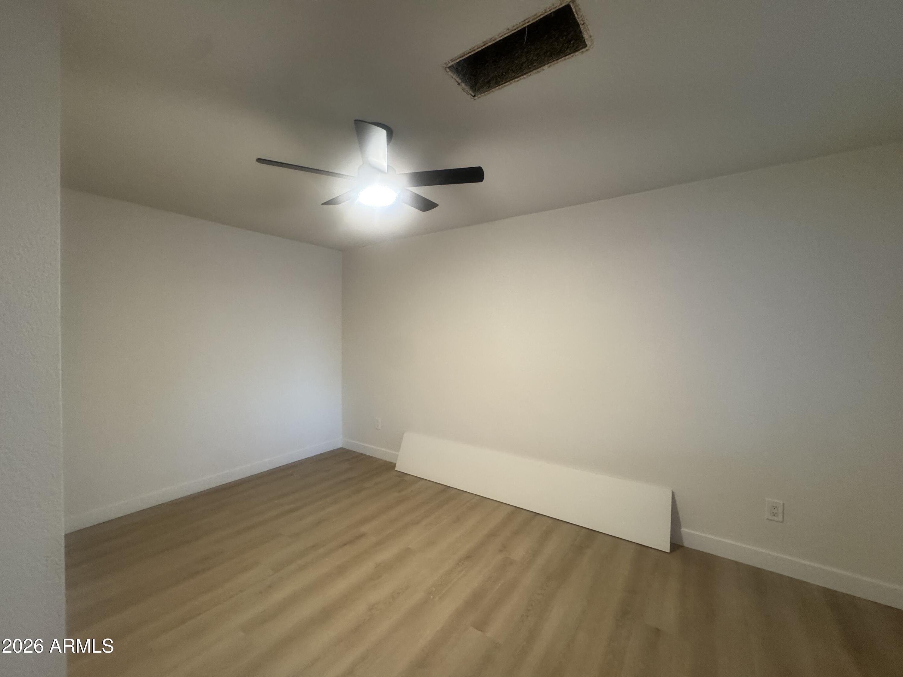 3337 West Ocotillo Road Phoenix, AZ 85017 - Photo 22 of 22 an empty room with a empty space and a ceiling fan